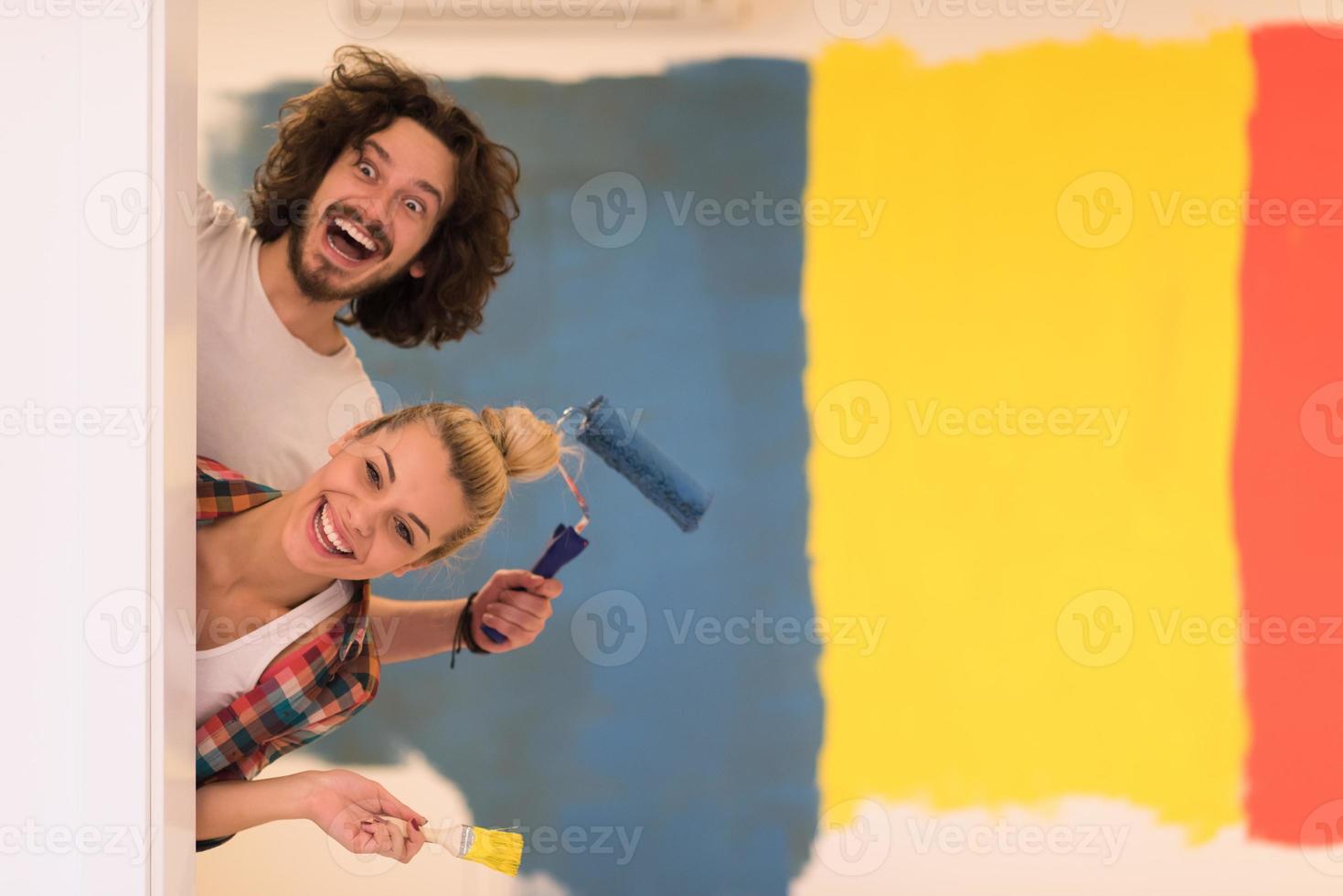 portrait of a couple painting interior wall photo