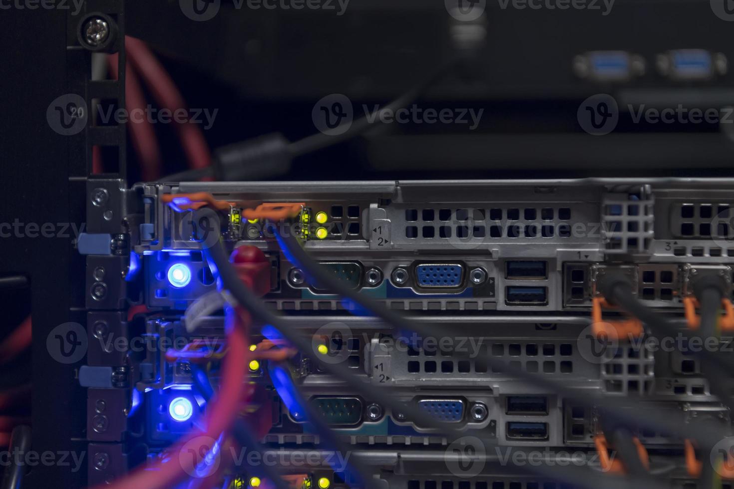 network server room closeup on fiber optic hub or switch for digital communications and internet in mainframe corporate business data center supercomputer. photo