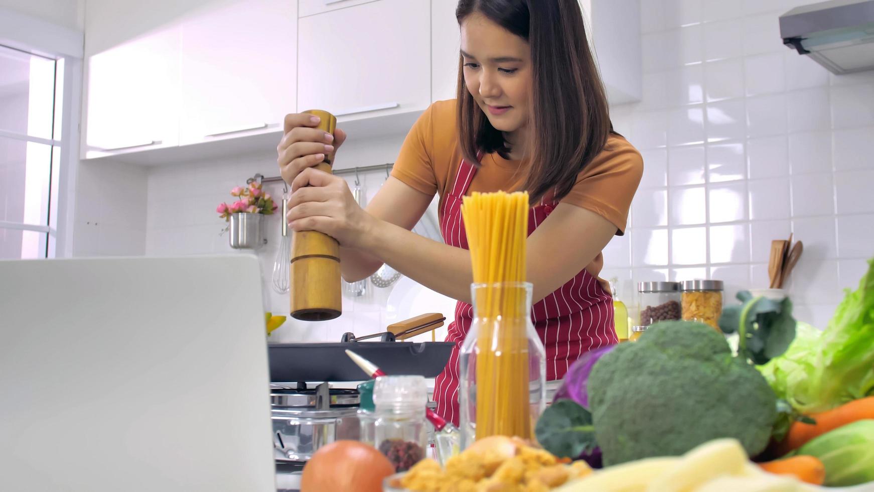 Young Asian woman cooking in kitchen at home. photo