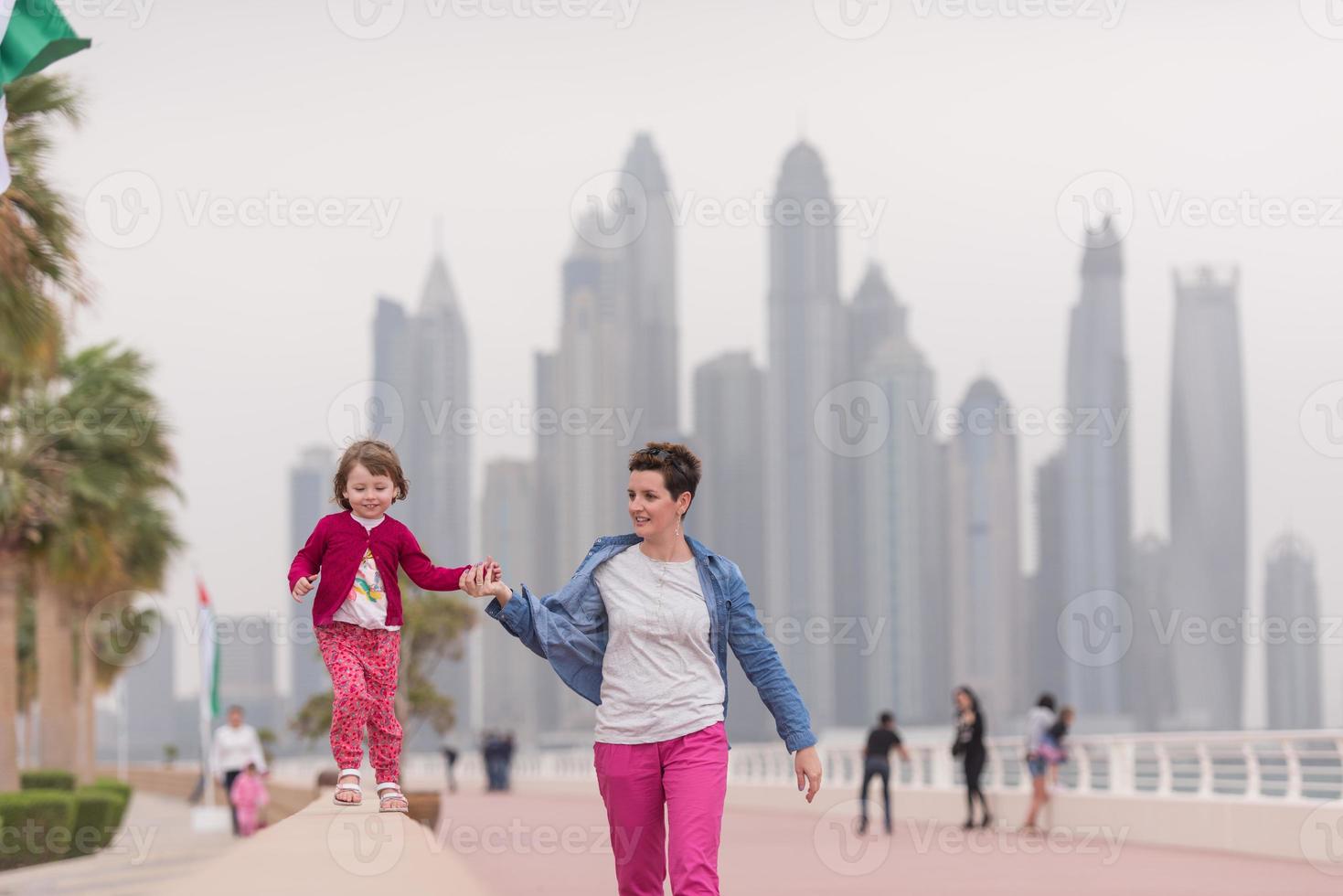 mother and cute little girl on the promenade photo