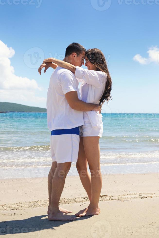 happy couple have fun on the beach photo