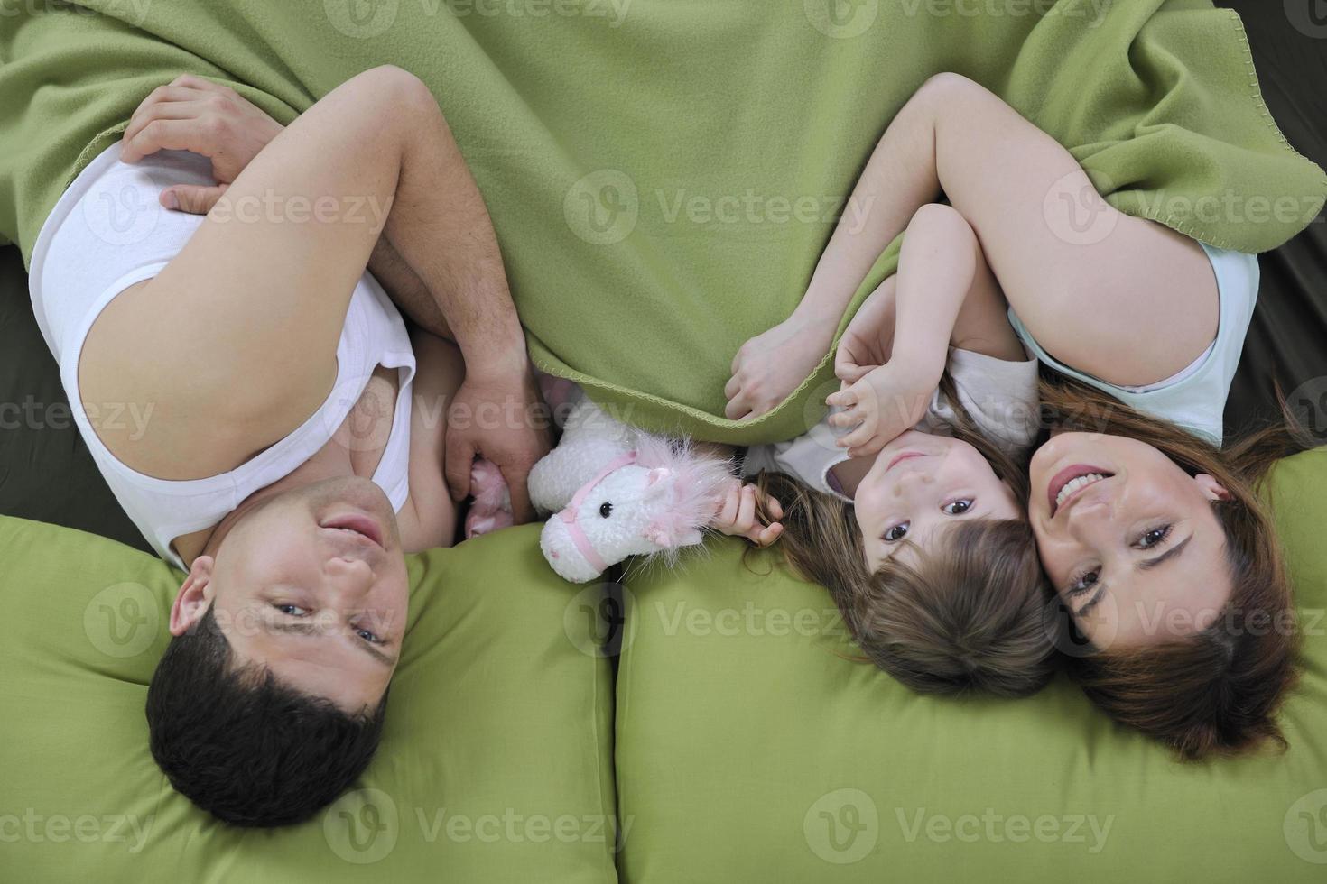happy young family eat breakfast in bed photo