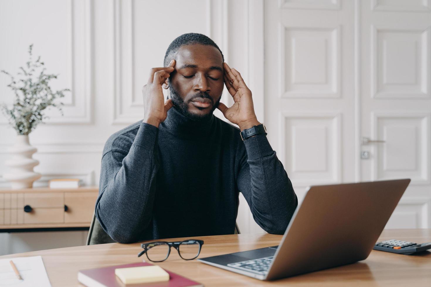 Frustrated tired afro american man office worker with closed eyes