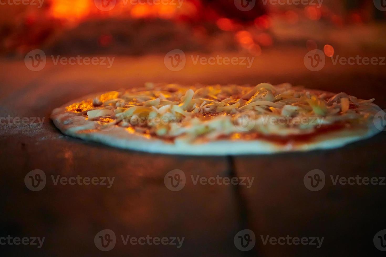 rustic pizza in wood fired oven photo