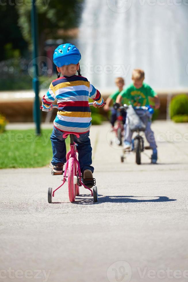 happy boy learning to ride his first bike photo