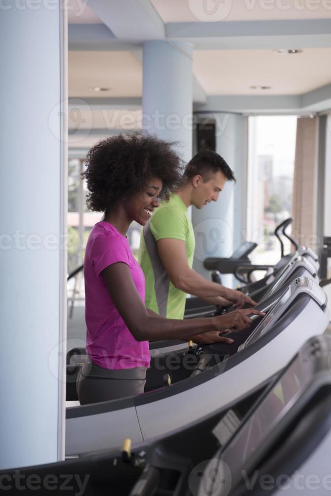 people exercisinng a cardio on treadmill in gym photo