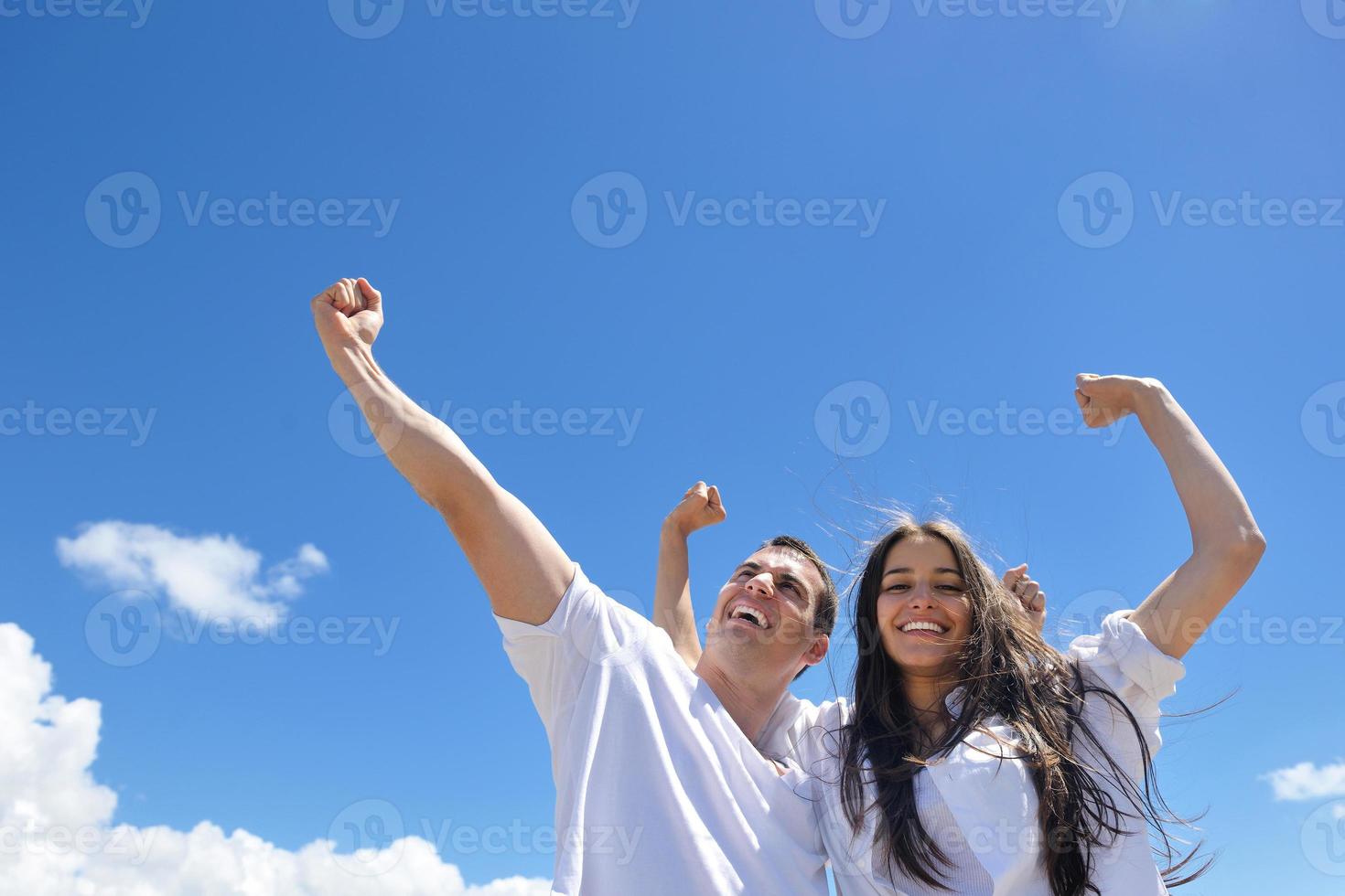 happy couple have fun on the beach photo