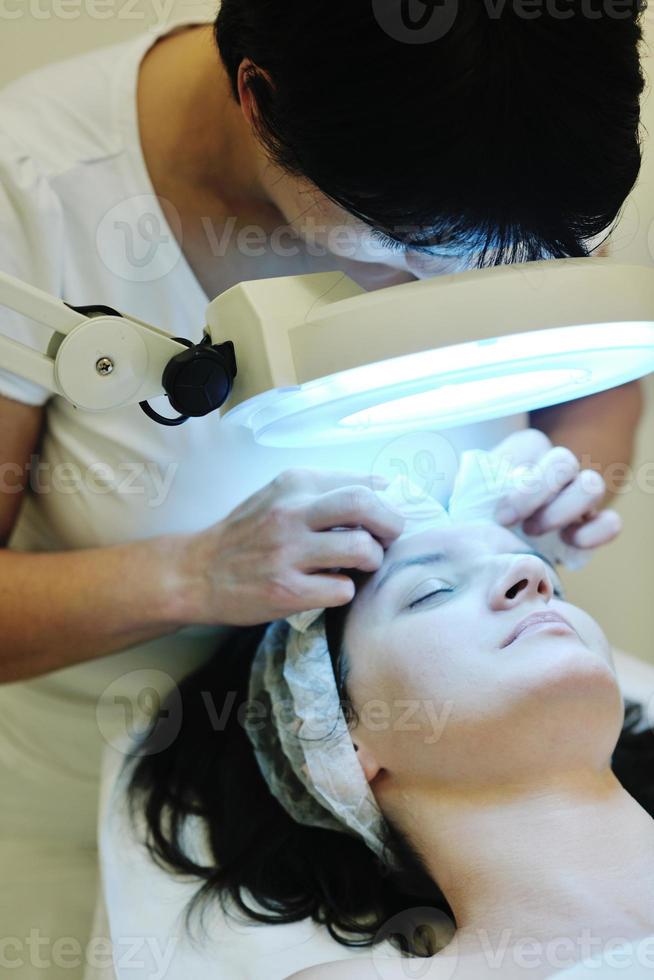 woman with facial mask in cosmetic studio photo