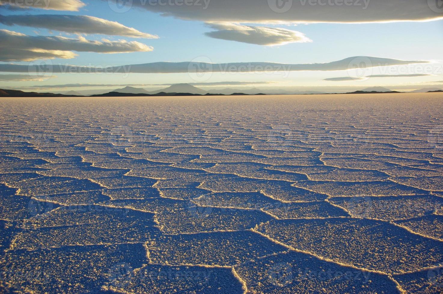 Gorgeous patterns on the surface of the salt flats of Salar de Uyuni, Bolivia, during sunset photo