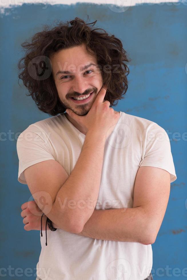 young man with funny hair over color background photo