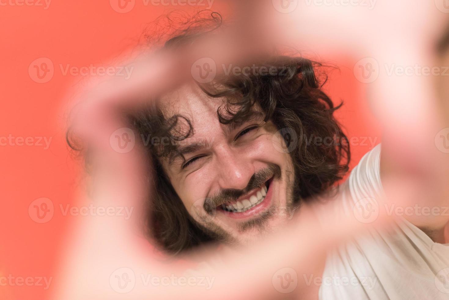 young man with funny hair over color background photo