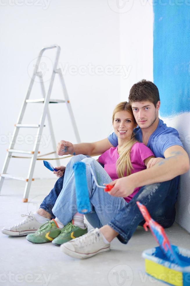 happy young cople relaxing after painting in new home photo