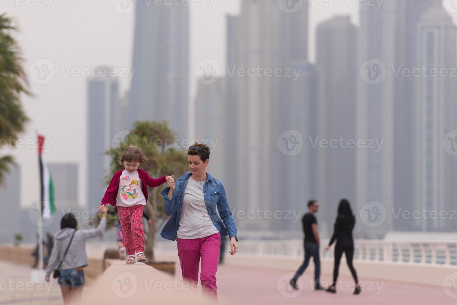 mother and cute little girl on the promenade photo