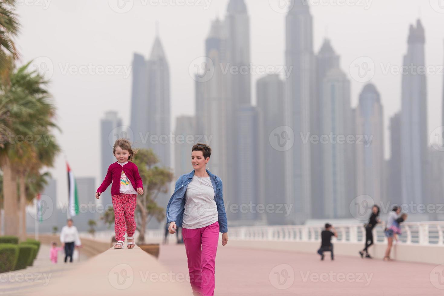 mother and cute little girl on the promenade photo