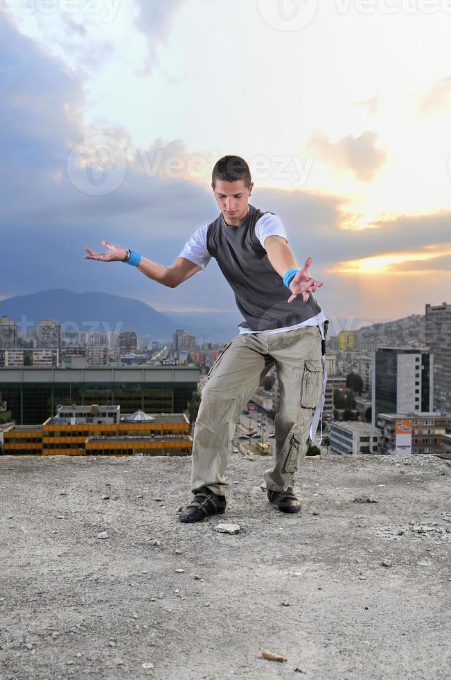young man jumping in air outdoor at night ready to party photo