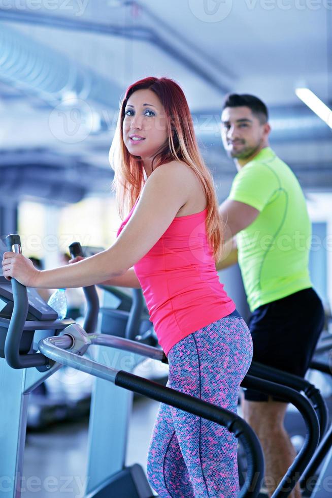 Group of people running on treadmills photo