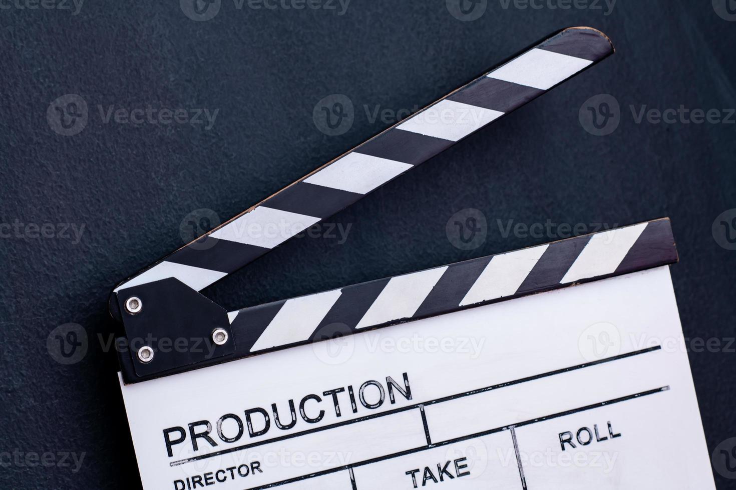 movie clapper on black chalkboard background photo