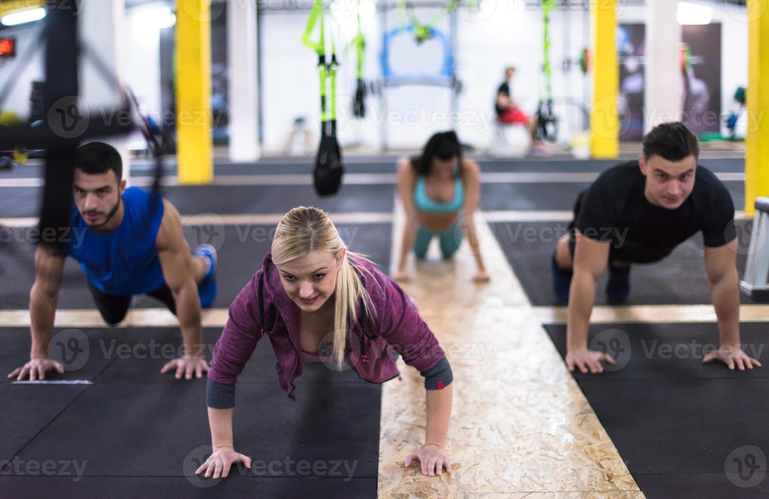 young healthy people doing pushups photo