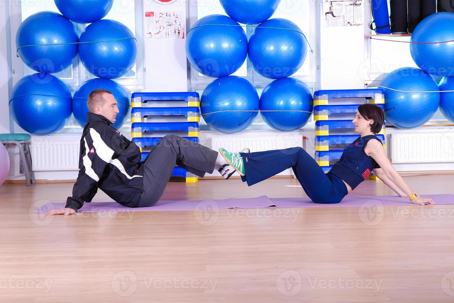 .happy couple at gym working out photo