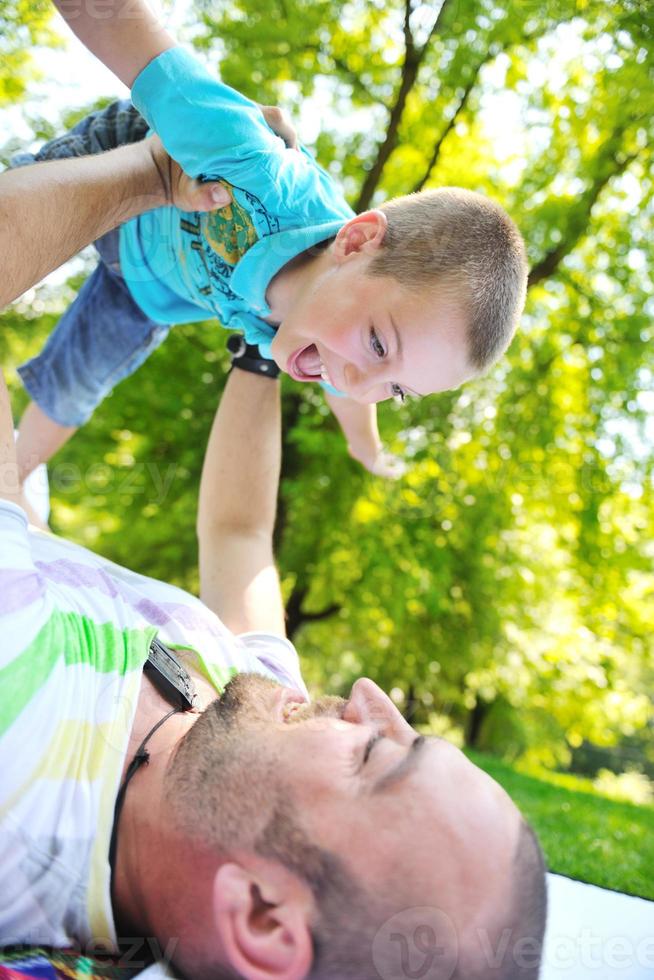 happy father and son have fun at park photo