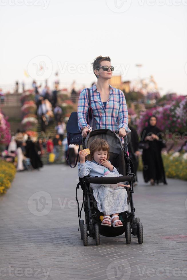 mother and daughter in flower garden photo