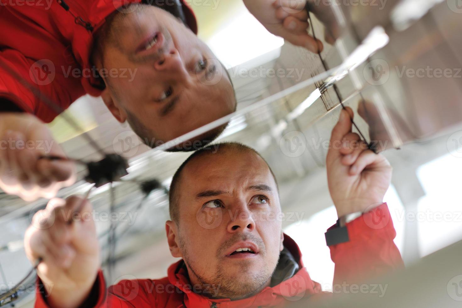 Male solar panel engineer at work place photo