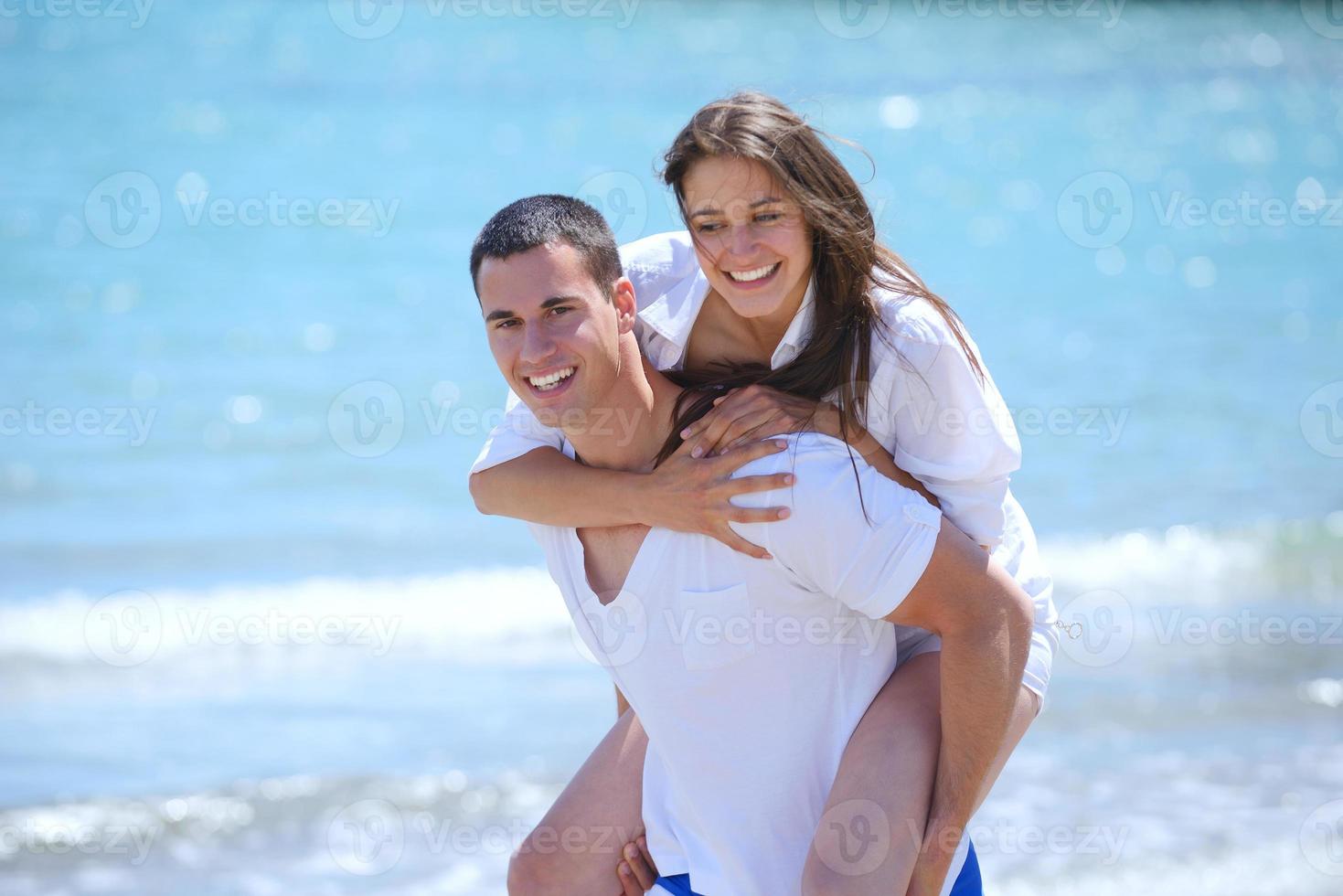 happy couple have fun on the beach photo