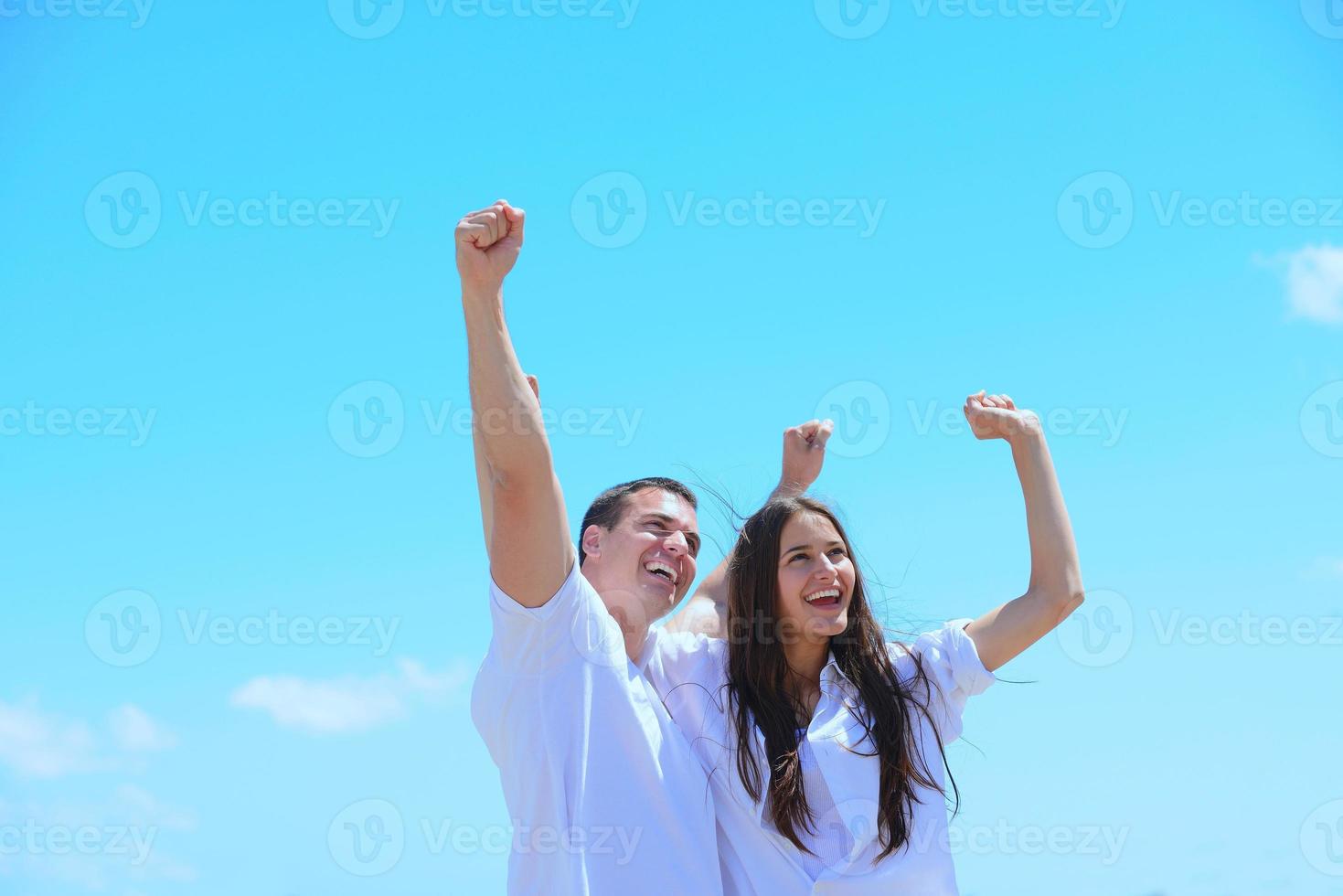happy couple have fun on the beach photo