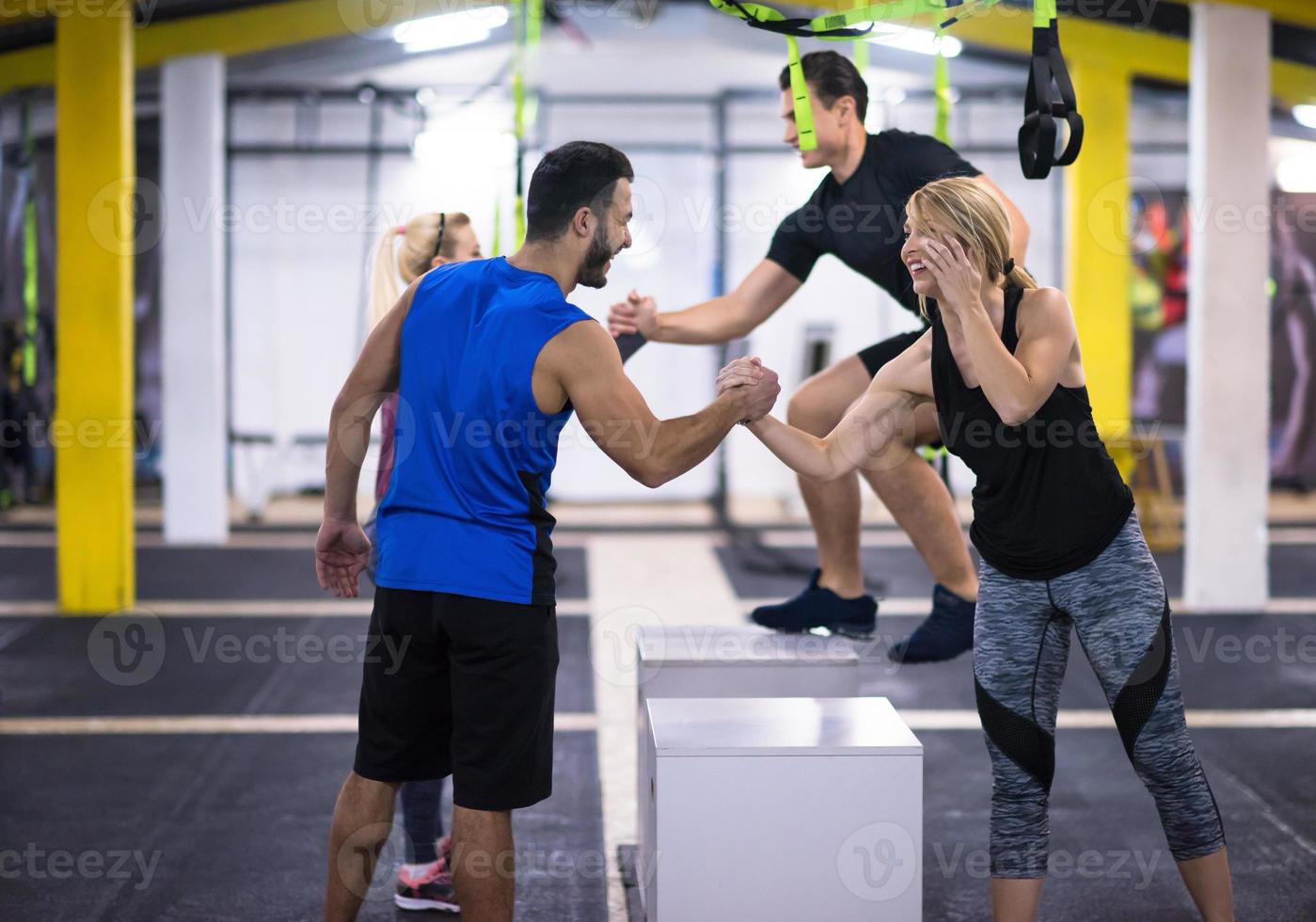 athletes working out  jumping on fit box photo
