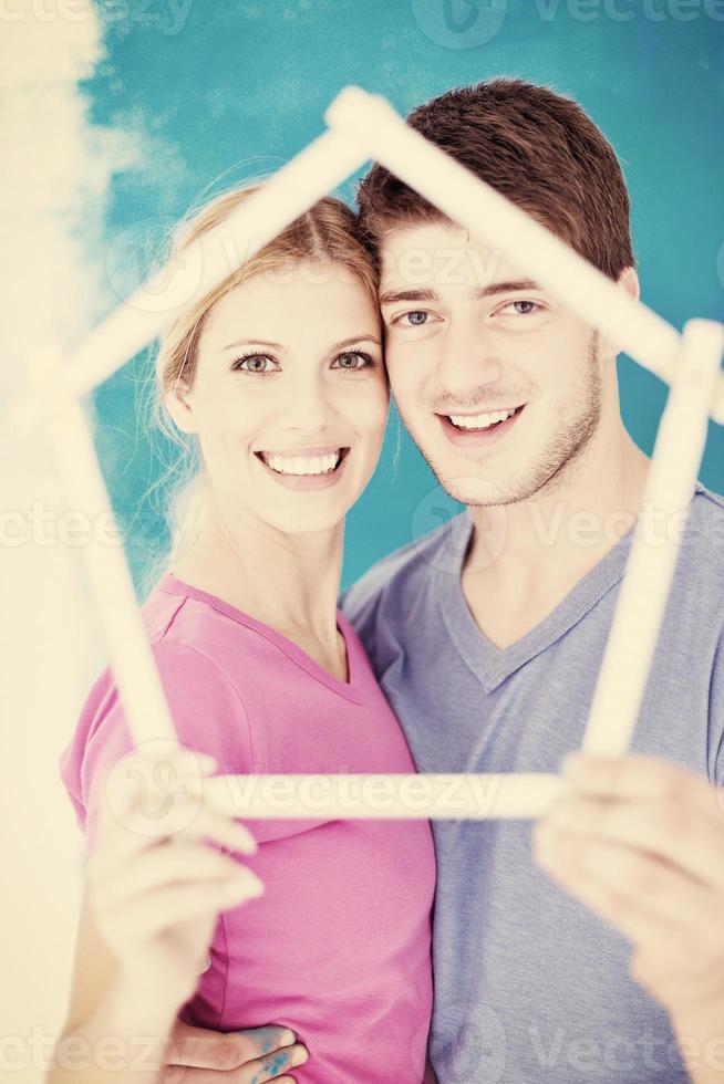 happy couple paint wall at new home photo