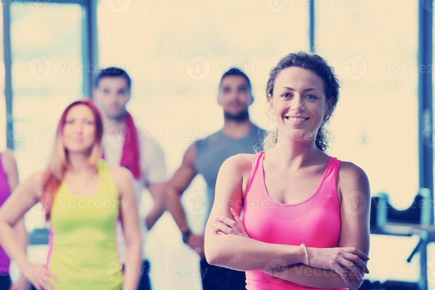 Group of people exercising at the gym photo