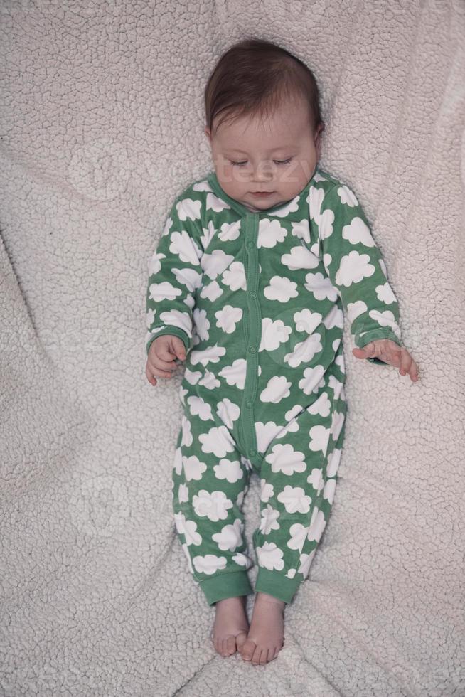 cute little baby playing with hands and smiling photo