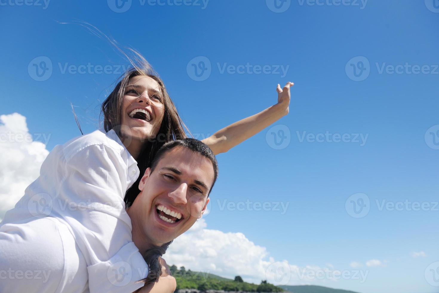 happy couple have fun on the beach photo