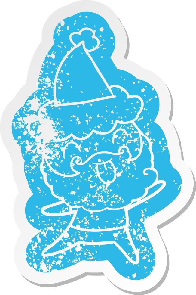 distressed sticker of a man with beard sticking out tongue wearing santa hat vector