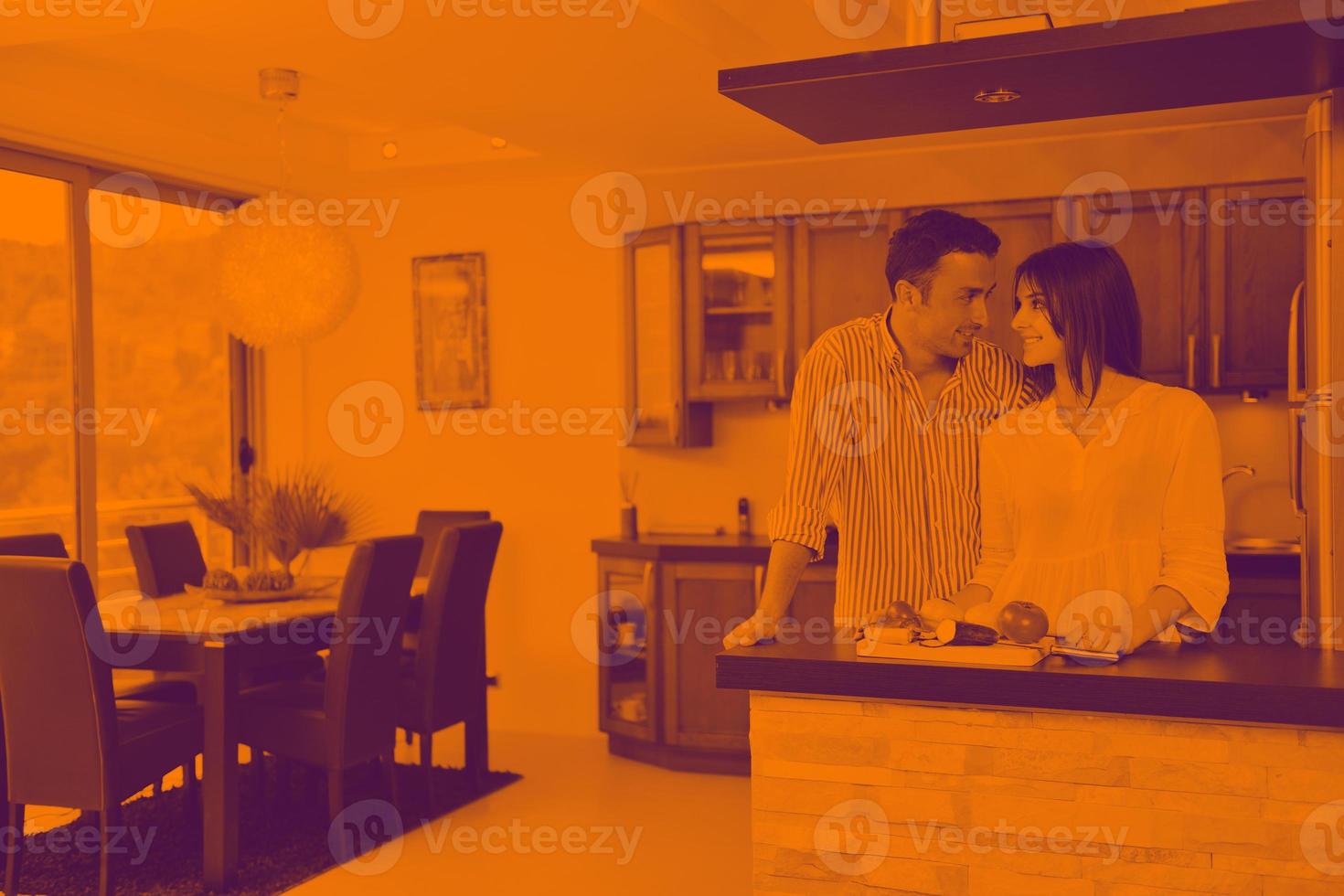 happy young couple have fun in modern kitchen photo