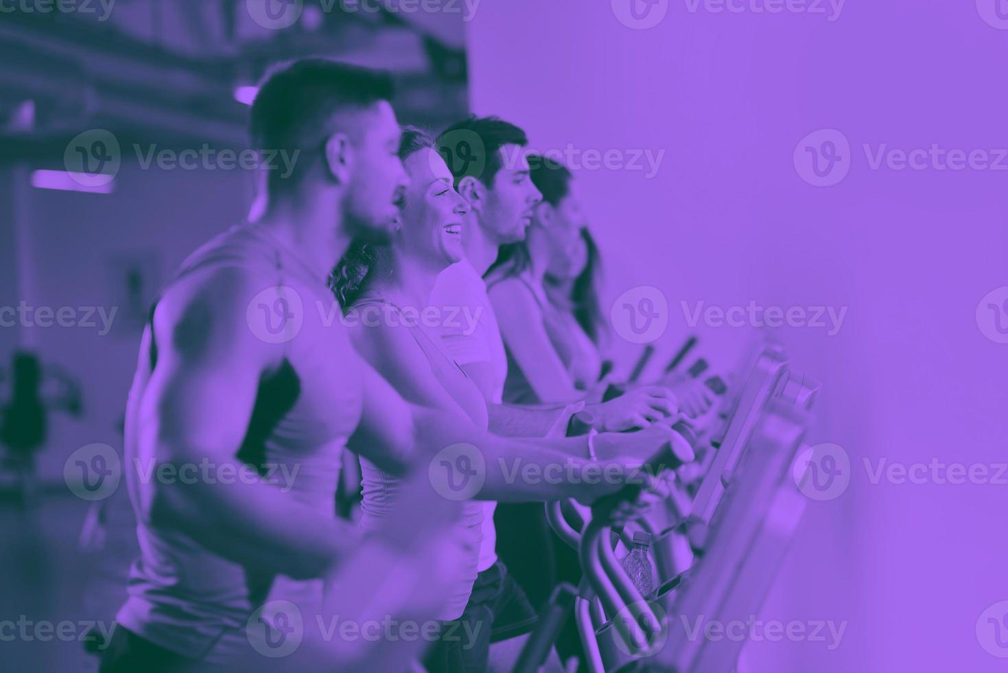Group of people running on treadmills photo