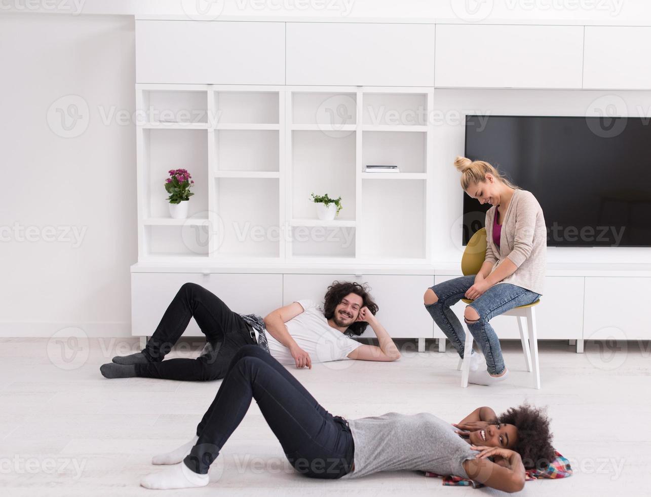 multiethnic group of people relax in their new apartment photo