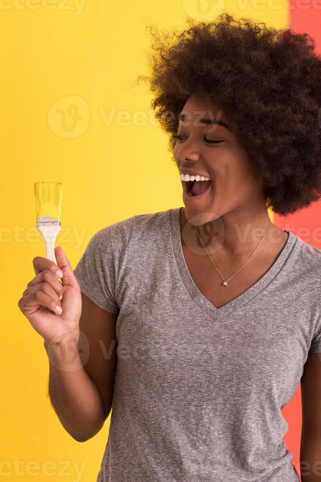 black woman painting wall photo