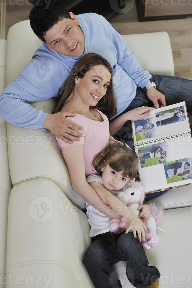 happy family looking photos at home