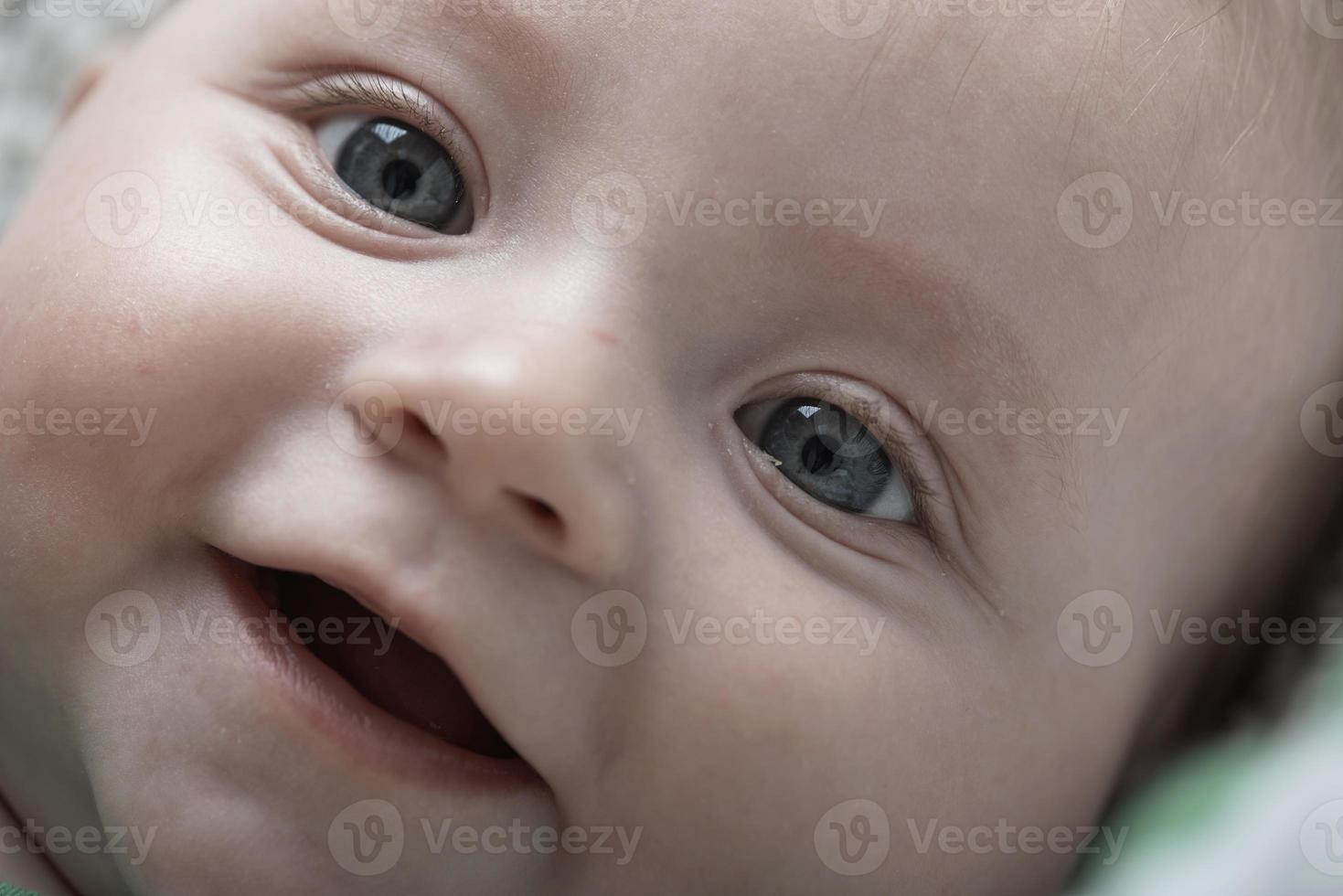 cute little baby playing with hands and smiling photo