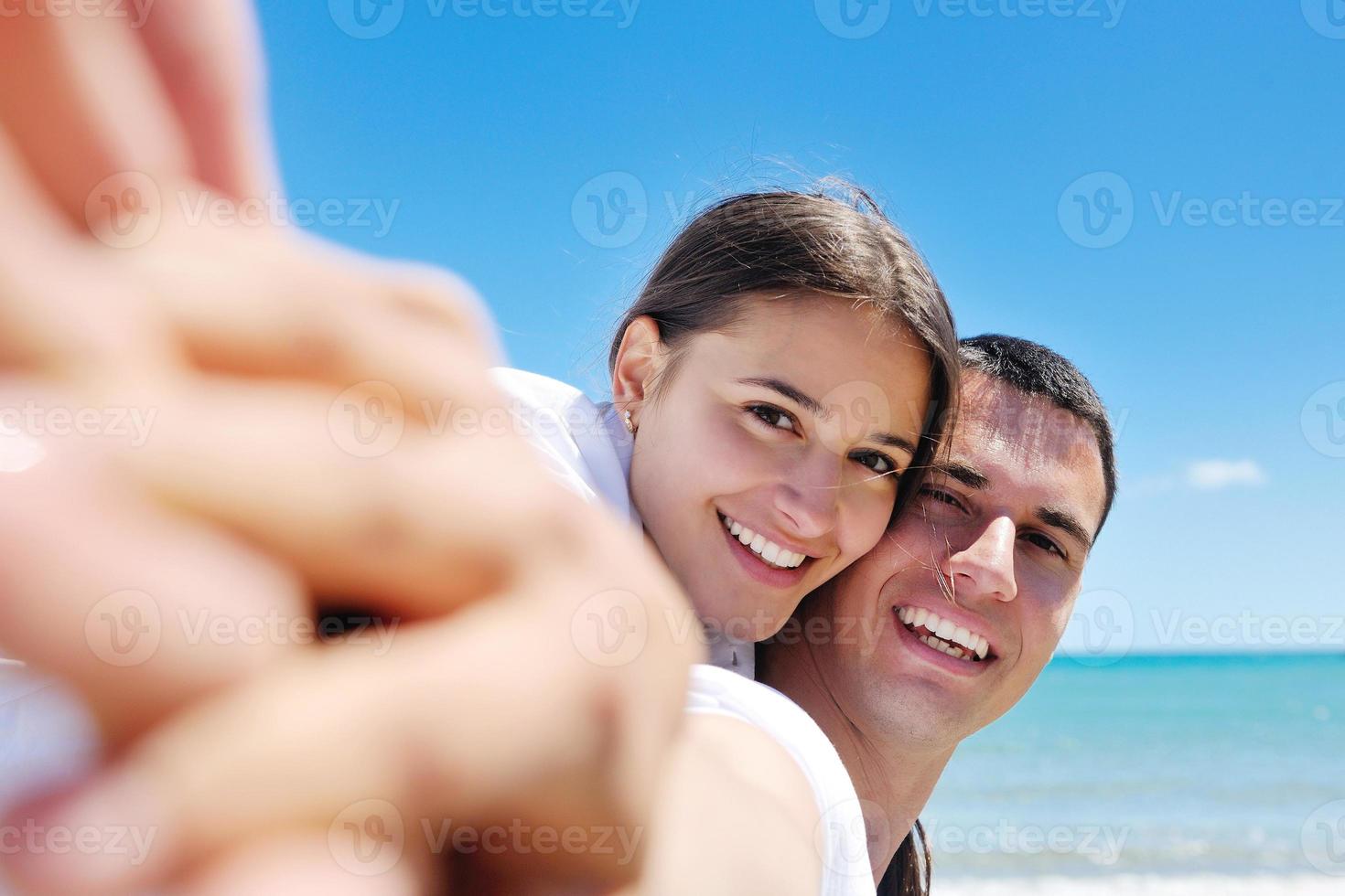 happy couple have fun on the beach photo