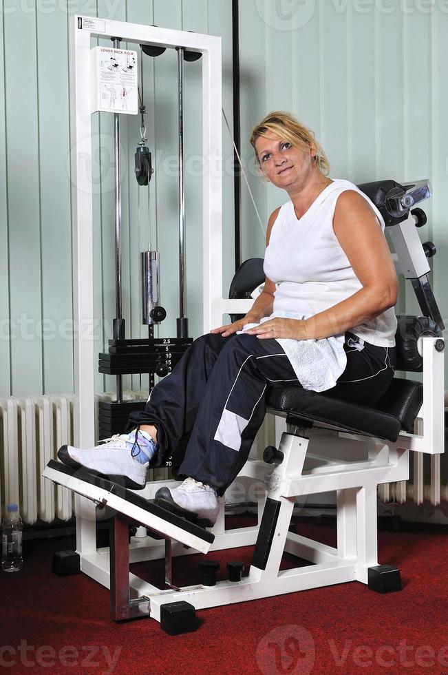 Mature  woman work out in fitness photo