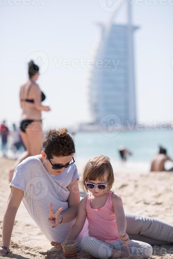 Mom and daughter on the beach photo