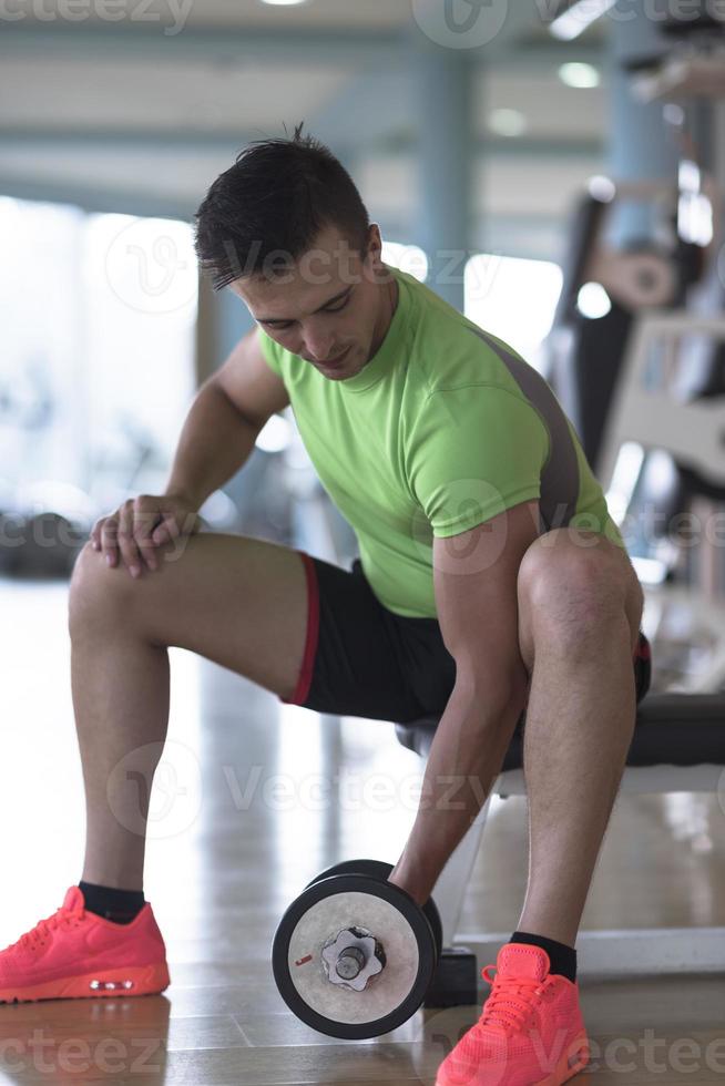 handsome man working out with dumbbells photo