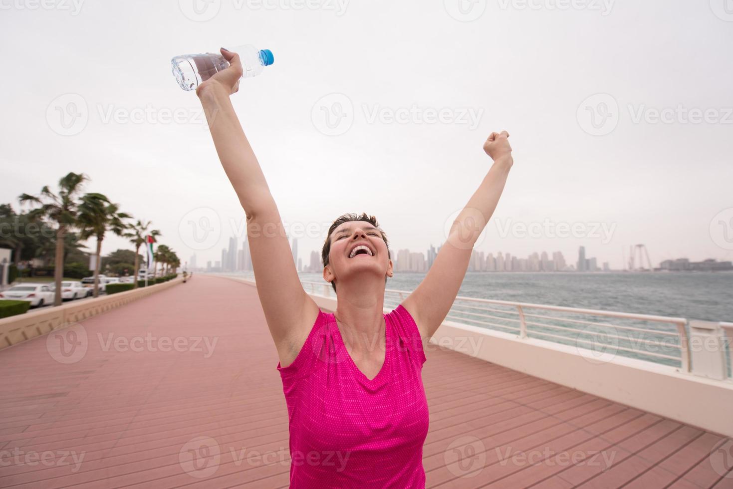 young woman celebrating a successful training run photo