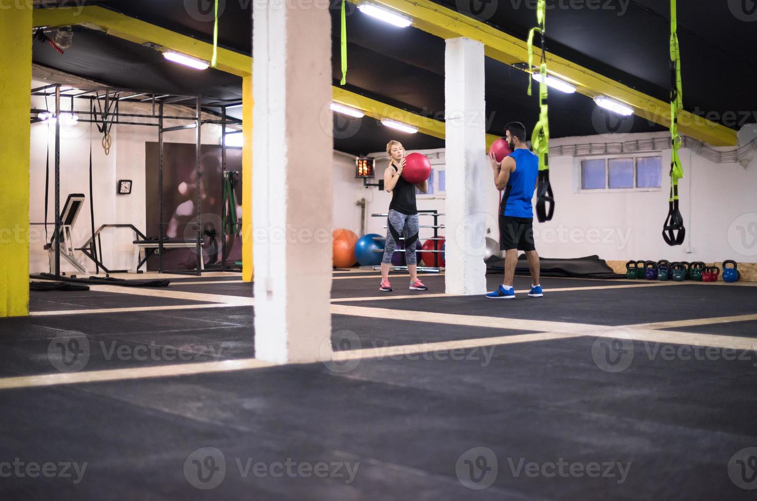 young athletes couple working out with medical ball photo