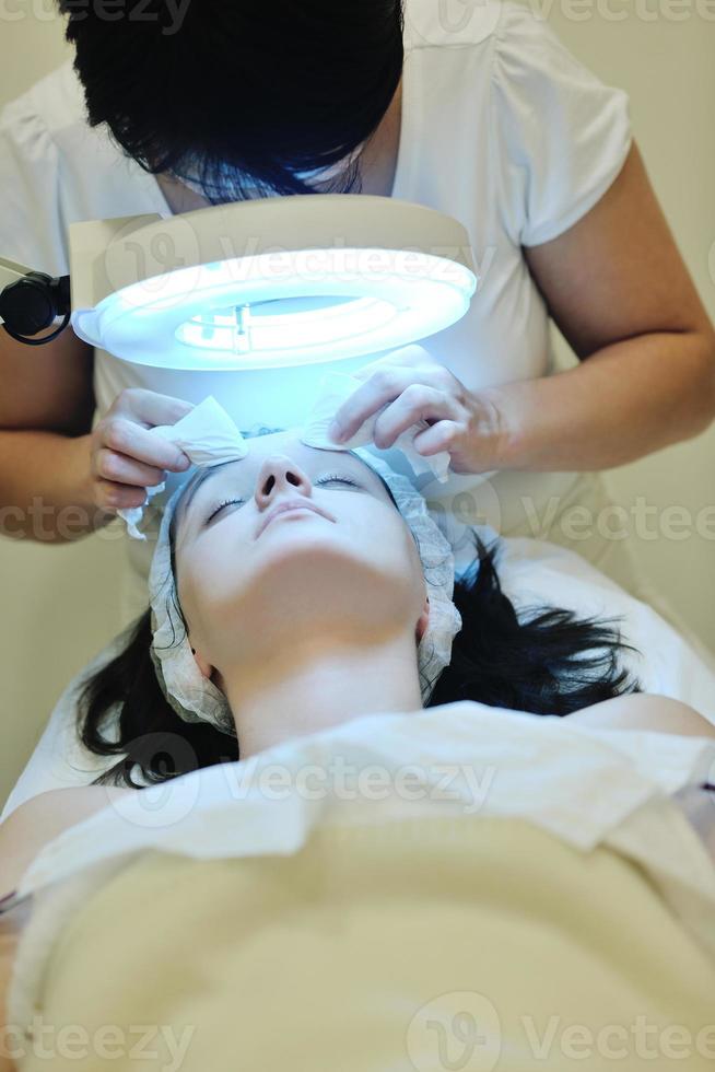 woman with facial mask in cosmetic studio photo