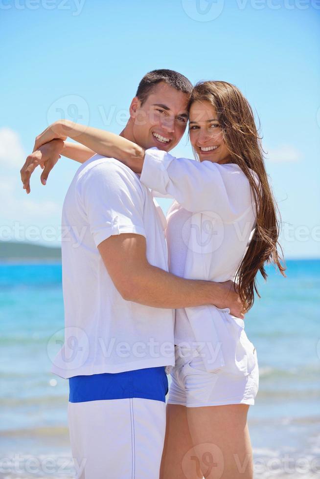 happy couple have fun on the beach photo