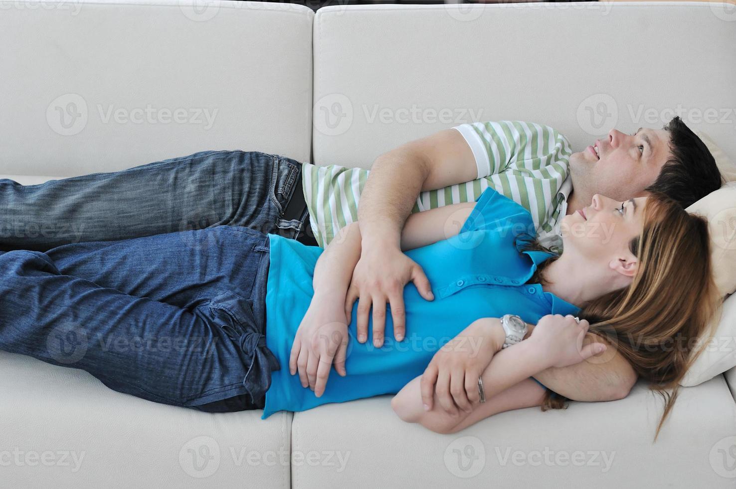 couple relax at home on sofa in living room photo