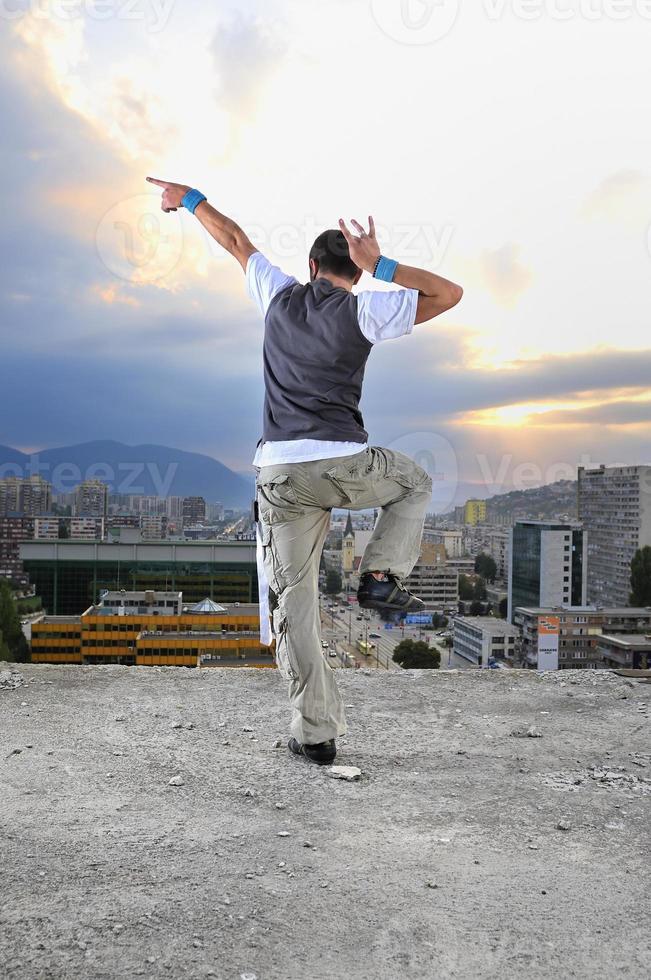 young man jumping in air outdoor at night ready to party photo